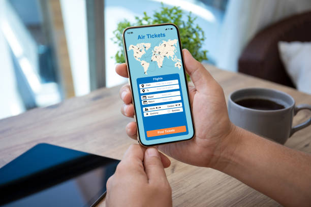 istock man hand holds phone with application searching air tickets 1385374024