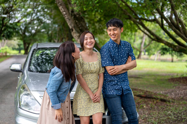 istock Three friends on a road trip taking a break at park 1385374233