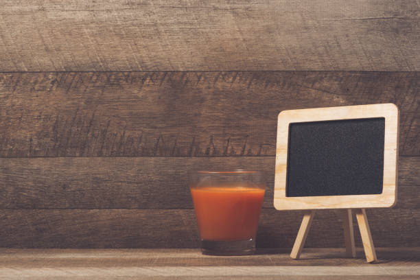 istock Carrot glass and chalkboard. 1385376471
