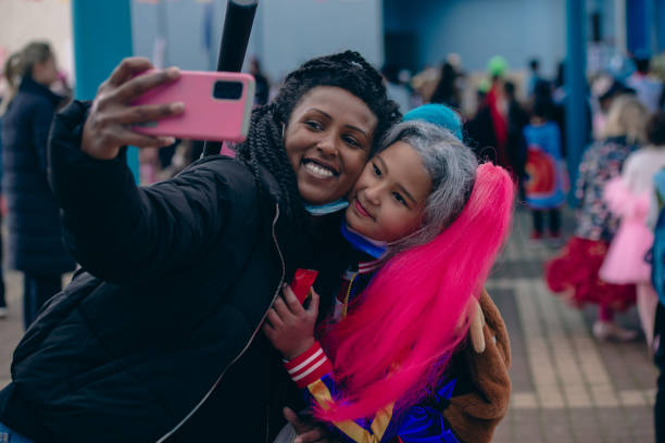 istock Mother taking a selfie with her daughter at a school carnival event. 1385376526