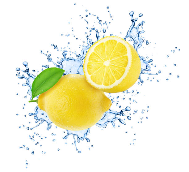 istock Halved and whole lemons in water splash isolated on white background. 1385376628