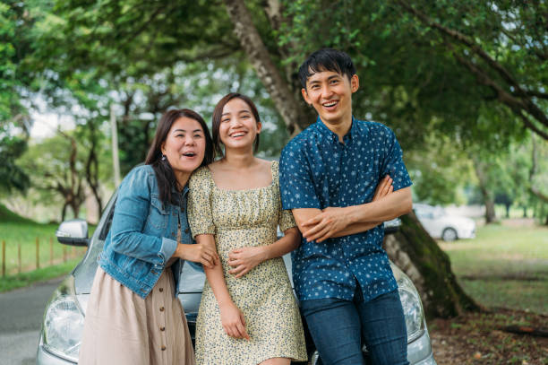 istock Three friends on a road trip taking a break at park 1385376945
