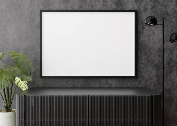 istock Empty horizontal picture frame on dark wall in modern living room. Mock up interior in contemporary style. Free, copy space for your picture, poster. Console, lamp, monstera plant. 3D rendering. 1385380842
