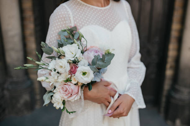 istock Wedding bouquet in hands of the bride. Rustic wedding bouquet. 1385384561