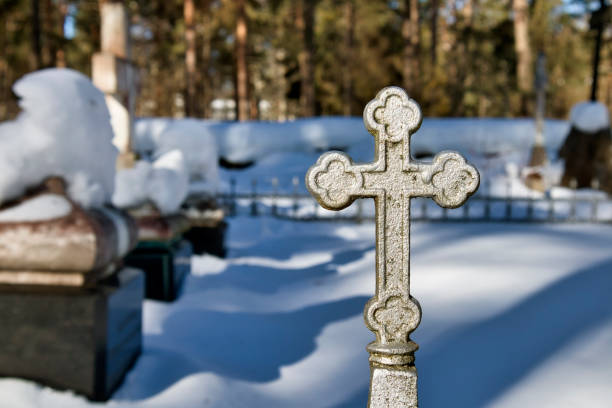 Ornate cross on the cemetery fence