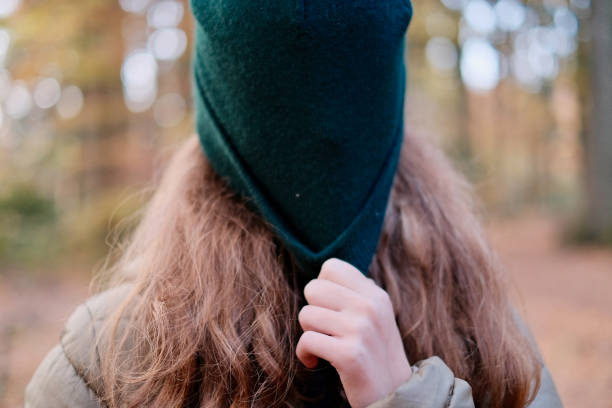 istock Teen with cap over his head 1385387575