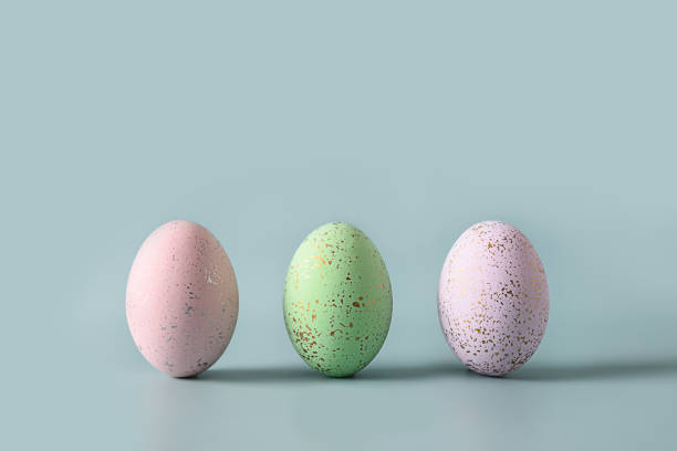 istock Three violet decorative pastel eggs. Happy Easter greeting card with copy space. Top view. 1385388935