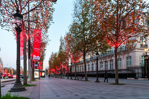 Paris : Christmas decoration on beautiful Champs-Elysees avenue, for Christmas with red light garlands in trees. Paris in France. December 2, 2020.