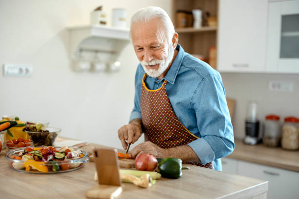 istock Senior Man Following Recipe on Smartphone 1385392620