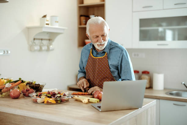 istock Senior Man Looking at Recipe on Laptop 1385394194