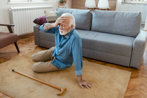 Health Problem Elderly Senior Man Slip And Fall. Fallen Old Person in the Living Room stroke illness photos stock pictures, royalty-free photos & images