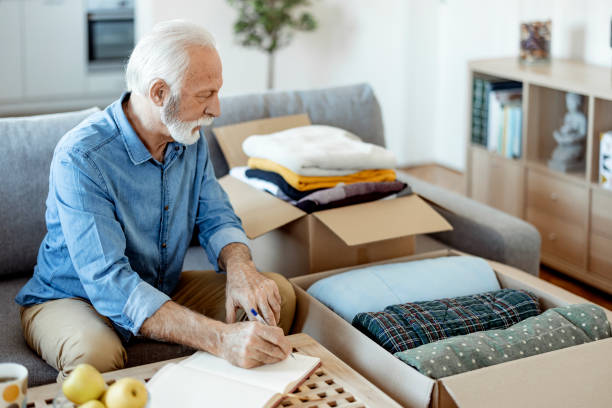 istock Senior man preparing clothes for Donation 1385394651