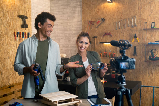 istock Two people in a carpentry workshop being filmed with a camera for a blog 1385398365