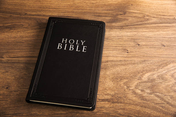 istock Holy Bible on the wooden table 1385402588