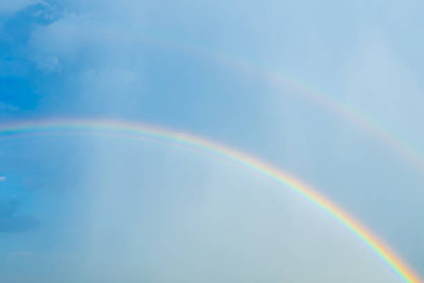 istock double rainbow in the sky during rain, clouds and blue sky. 1385402707