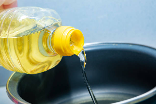 istock Sunflower oil, being poured into a cooking pot 1385407228