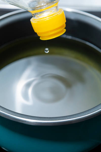 istock Sunflower oil, being poured into a cooking pot 1385407230