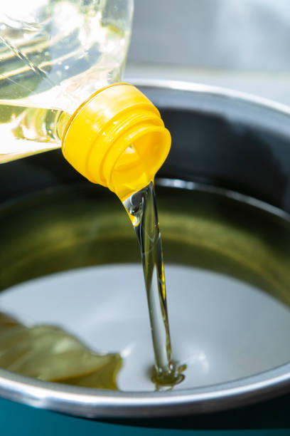 istock Sunflower oil, being poured into a cooking pot 1385407237