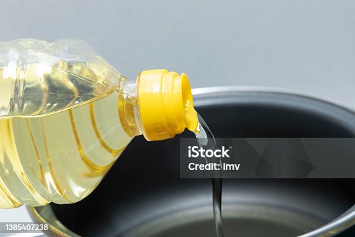 istock Sunflower oil, being poured into a cooking pot 1385407238
