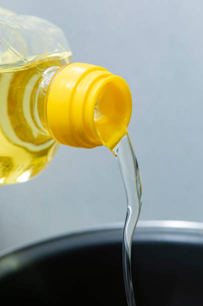 istock Sunflower oil, being poured into a cooking pot 1385407239