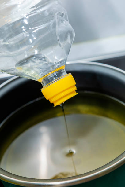 istock Sunflower oil, being poured into a cooking pot 1385407241