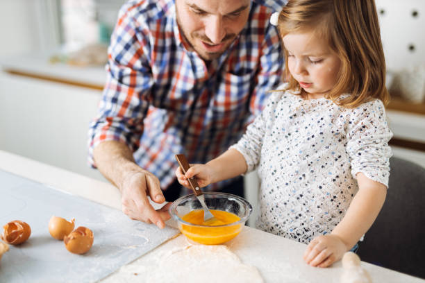 istock Father and daughter baking cookies 1385407331