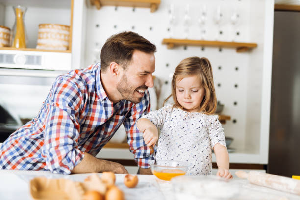 istock Father and daughter baking cookies 1385407483