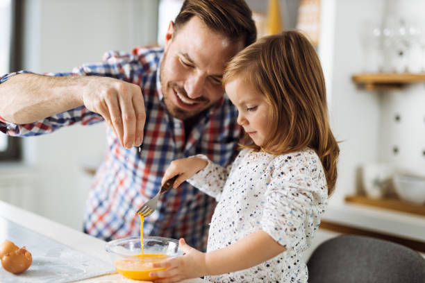 istock Father and daughter baking cookies 1385407629