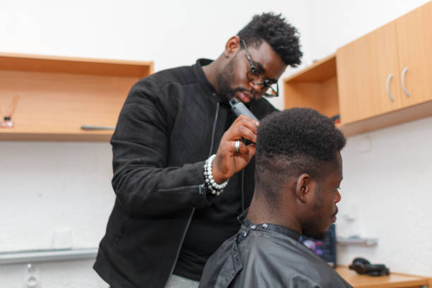 istock Young Man Getting A Haircut At Barber Shop 1385407793