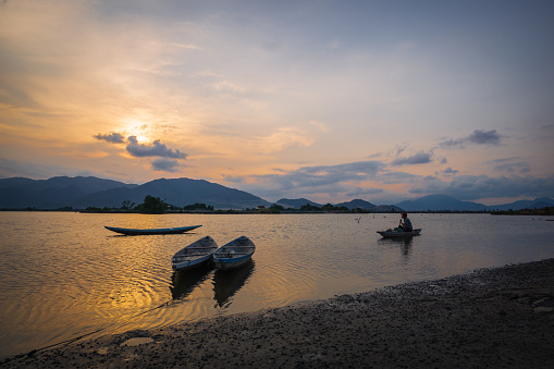 Fisherman on Quan Tuong river is preparing for a fishing trip in sunset, Nha Trang city, Khanh Hoa province