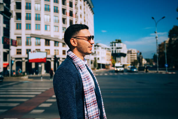 istock A stylish young man is being outdoors smiling and enjoying himself. 1385409433