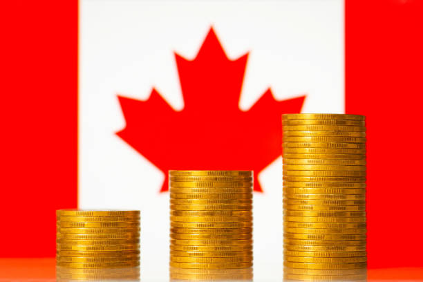 istock Coins stacks against flag of Canada 1385409494