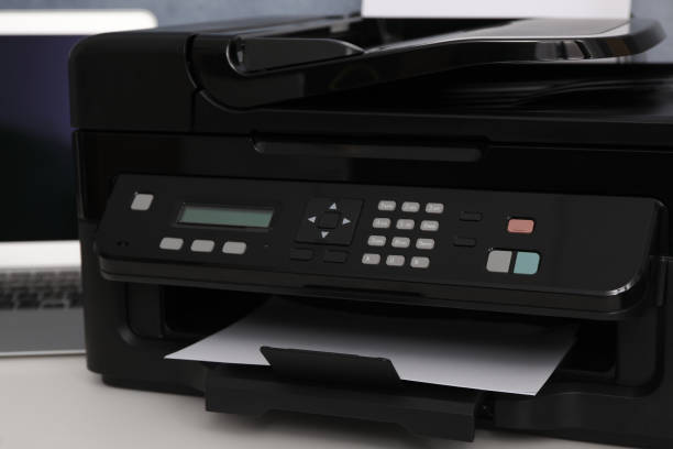 istock Closeup view of new modern printer with control panel on white table 1385412074