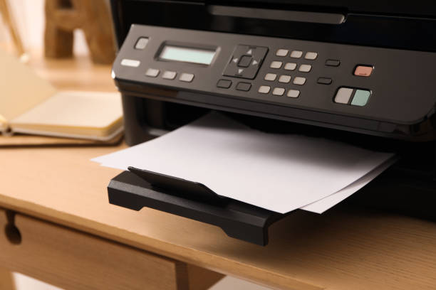 istock Closeup view of new modern printer with control panel on wooden table 1385412093