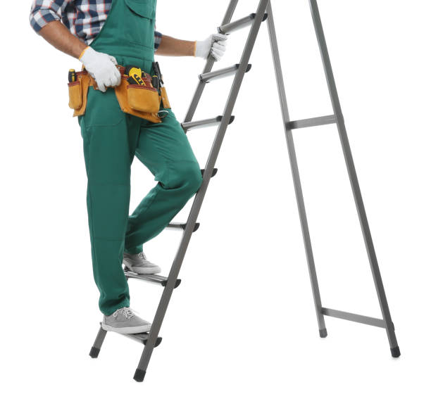 istock Professional builder climbing up metal ladder on white background, closeup 1385415061