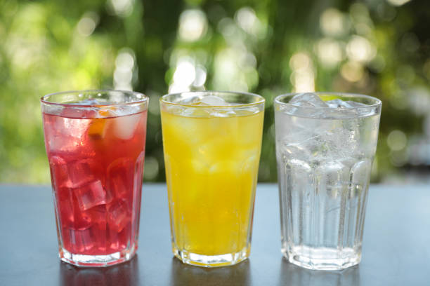 istock Delicious refreshing drinks in glasses on grey table outdoors 1385415624