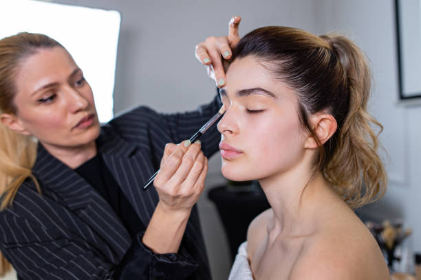istock Makeup artist applying eyeshadow on a fashion model 1385417995
