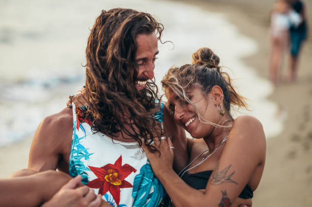 istock Attractive young couple in love having fun on the beach 1385418449