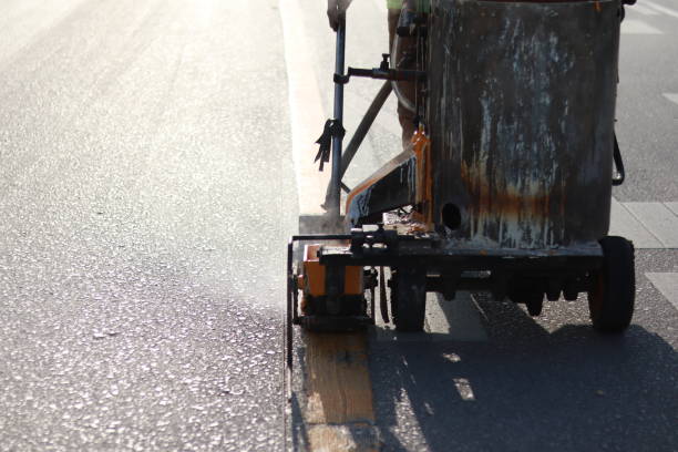 istock road workers repainting road markings 1385420946