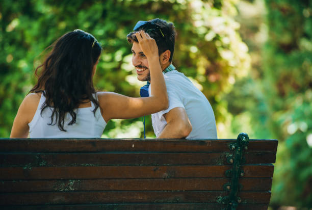 Happy woman and man embracing enjoying life and romance outside