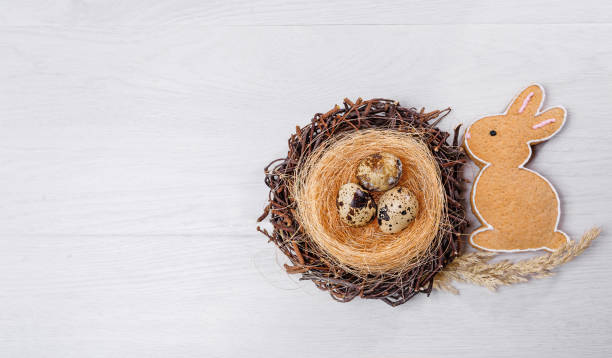 istock Easter background with colorful eggs in nest and a cookies rabbit 1385421150