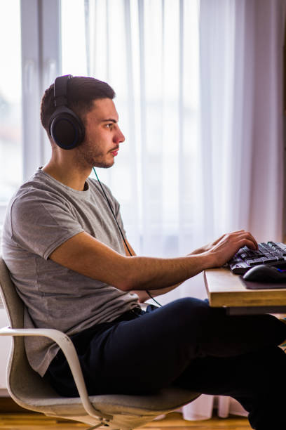 istock Young man working on pc in his room 1385422356