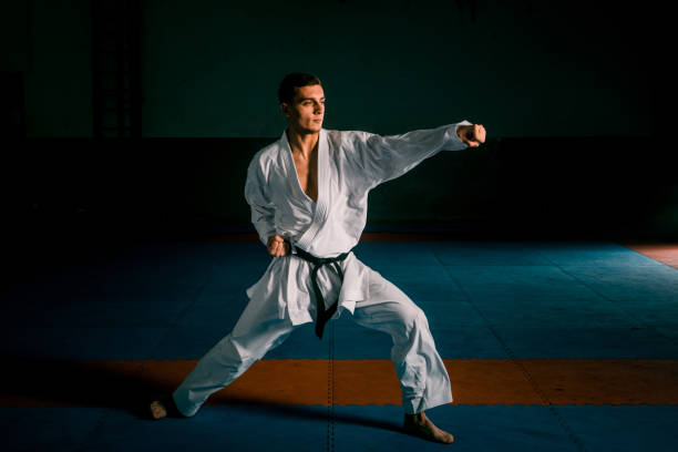 istock One karate kata training man isolated on dark background 1385424605