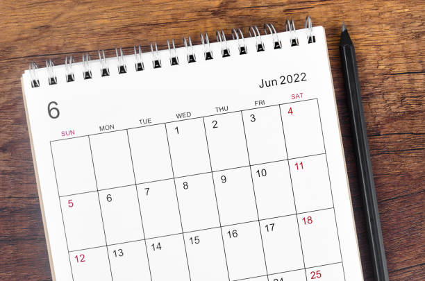 istock June 2022 desk calendar on wooden table. 1385427470