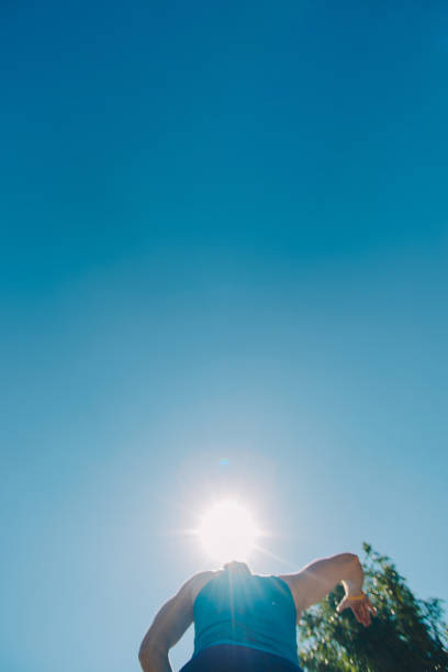 istock Healthy man running on a sunny day with blue sky 1385431980