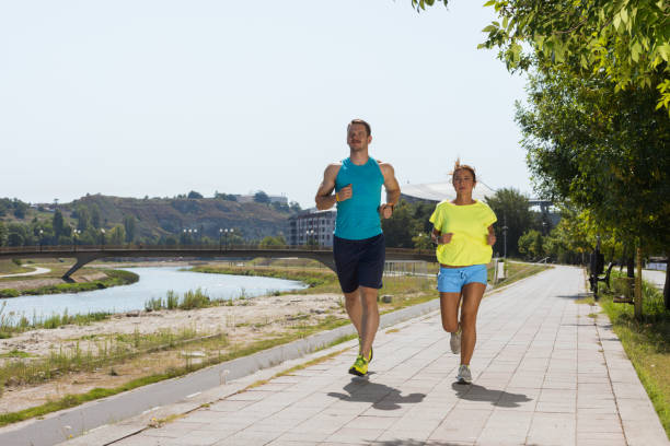 istock Young people jogging and exercising in nature 1385432185
