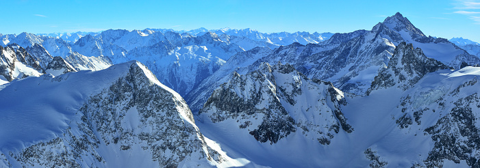 The craggy and rocky peaks of the Alps - Winter skiing on top of Titlis Glacier.