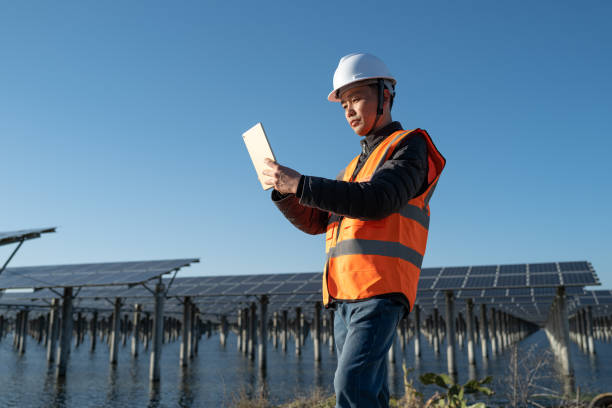 istock Male engineer of solar power plant in water using tablet 1385433488
