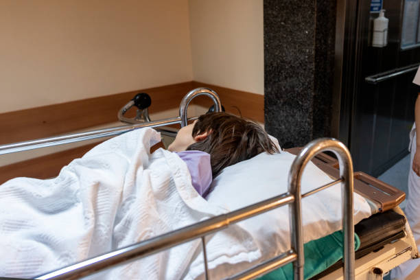 child being taken to surgery on stretcher stock photo