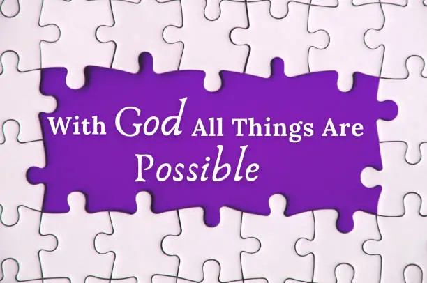 Text on missing jigsaw puzzle - With God all things are possible. With purple background. Religious concept